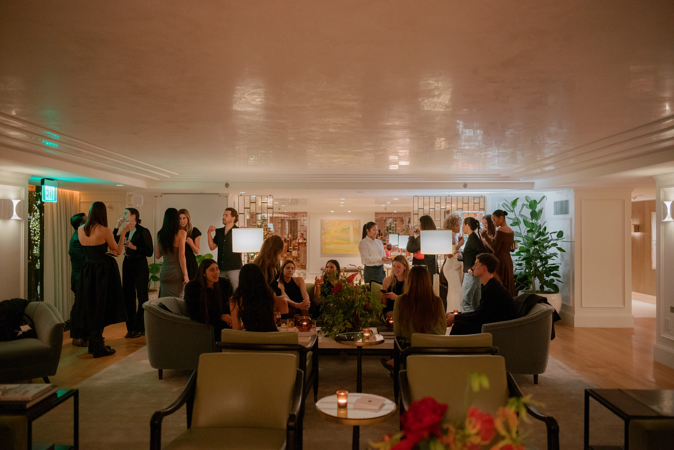 Evening cocktail gathering in spacious lounge.