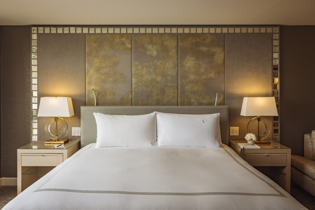 Luxury king bed with bedside lamps and textured headboard