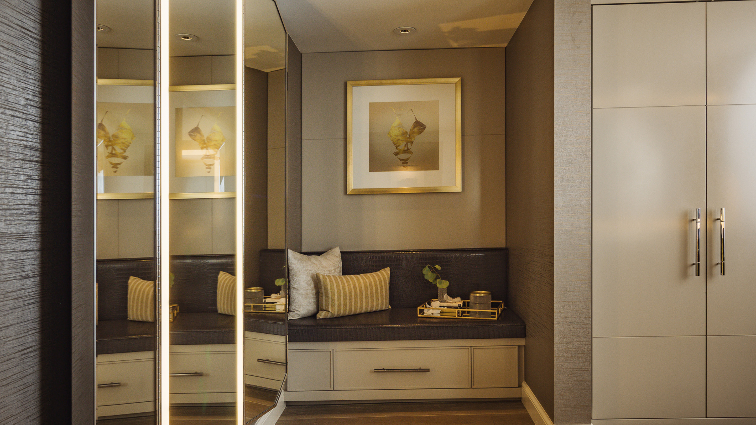 Classic suite closet nook with bench seating and mirrored doors