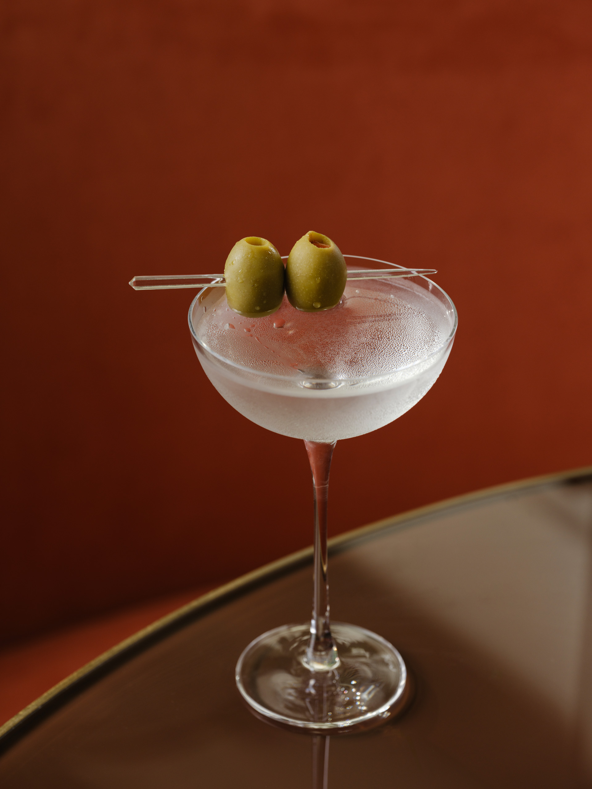 a cold martini with two olives
