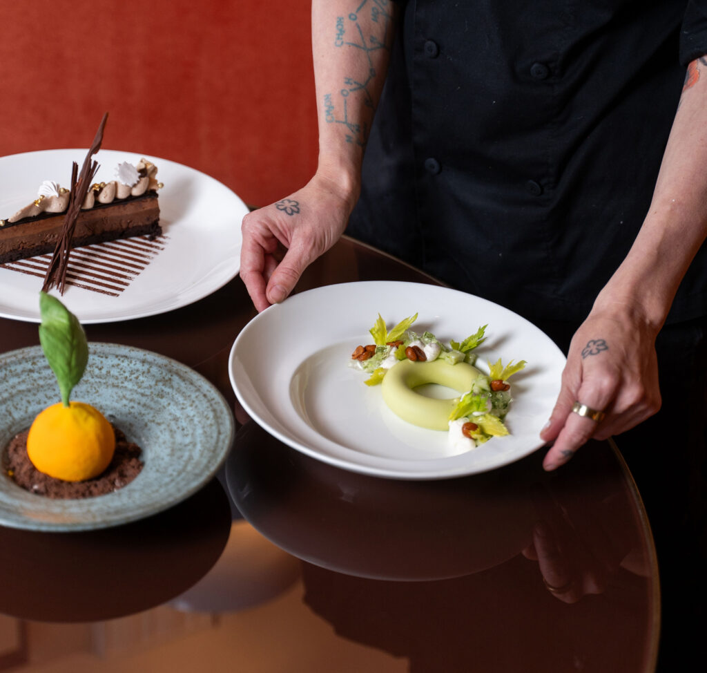 Chef plating desserts on table
