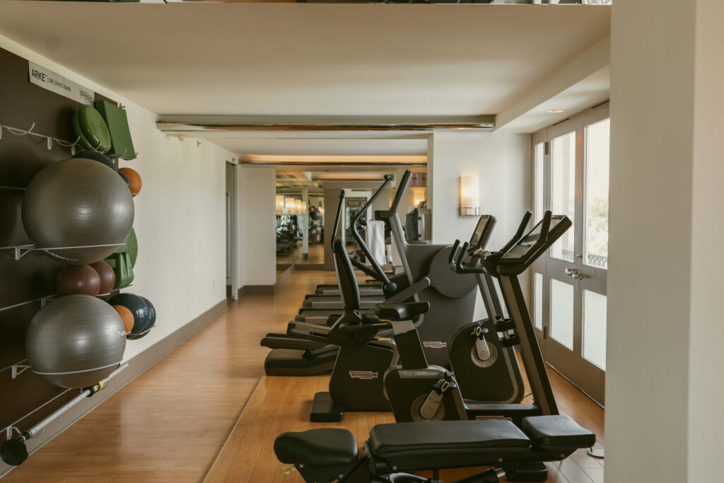 Fitness room with treadmills, bikes, and workout balls