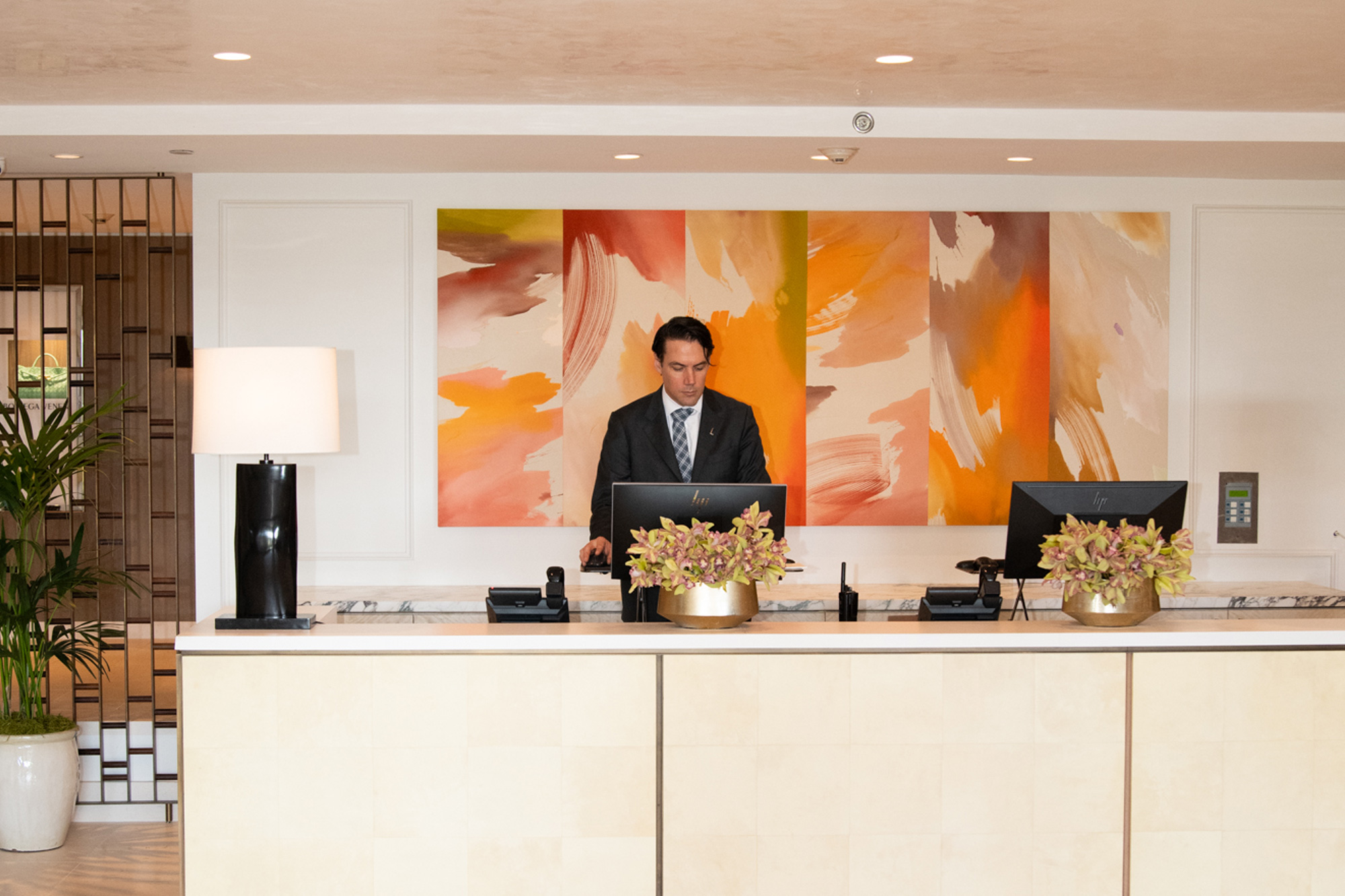 Concierge at front desk in bright hotel lobby