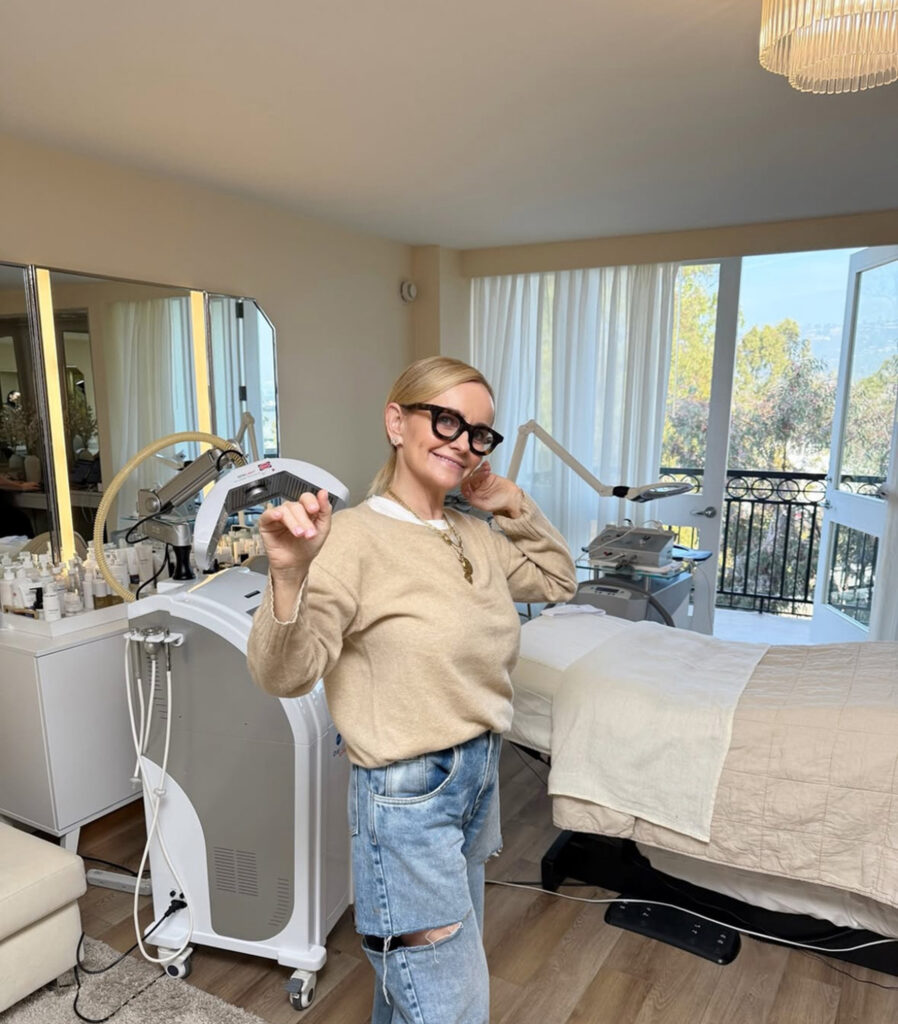 Joanna Czech posing inside bright skincare treatment room