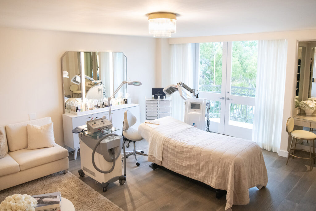 Minimal treatment room with bed, machines, and balcony doors