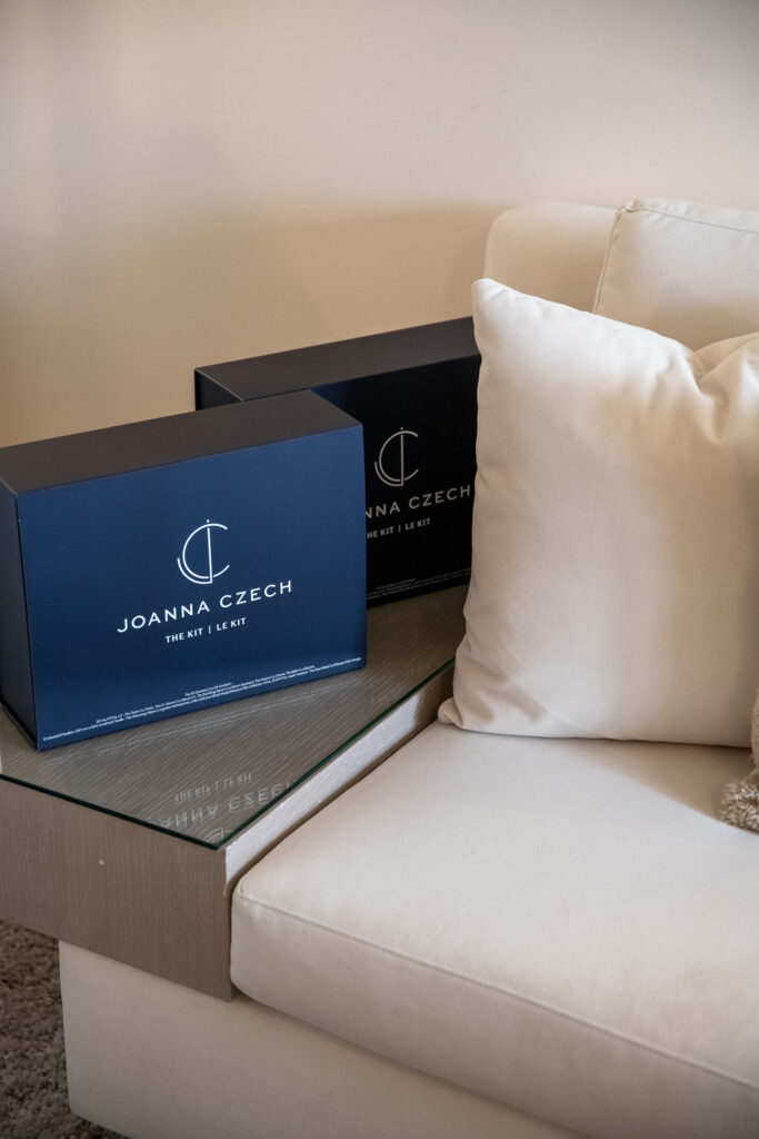 Joanna Czech kit boxes on couch-side glass table