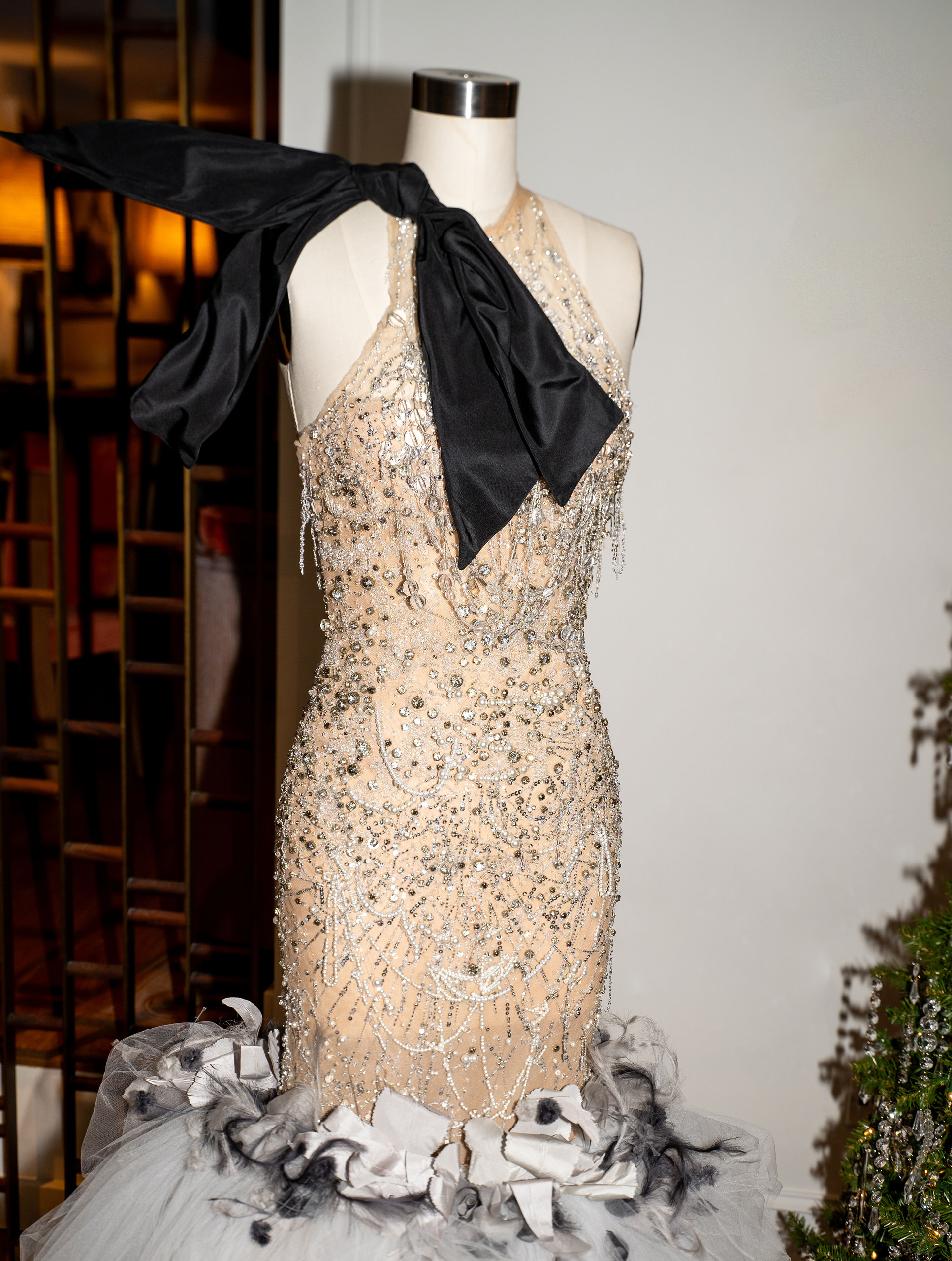 Embellished gown on mannequin with oversized black bow detail
