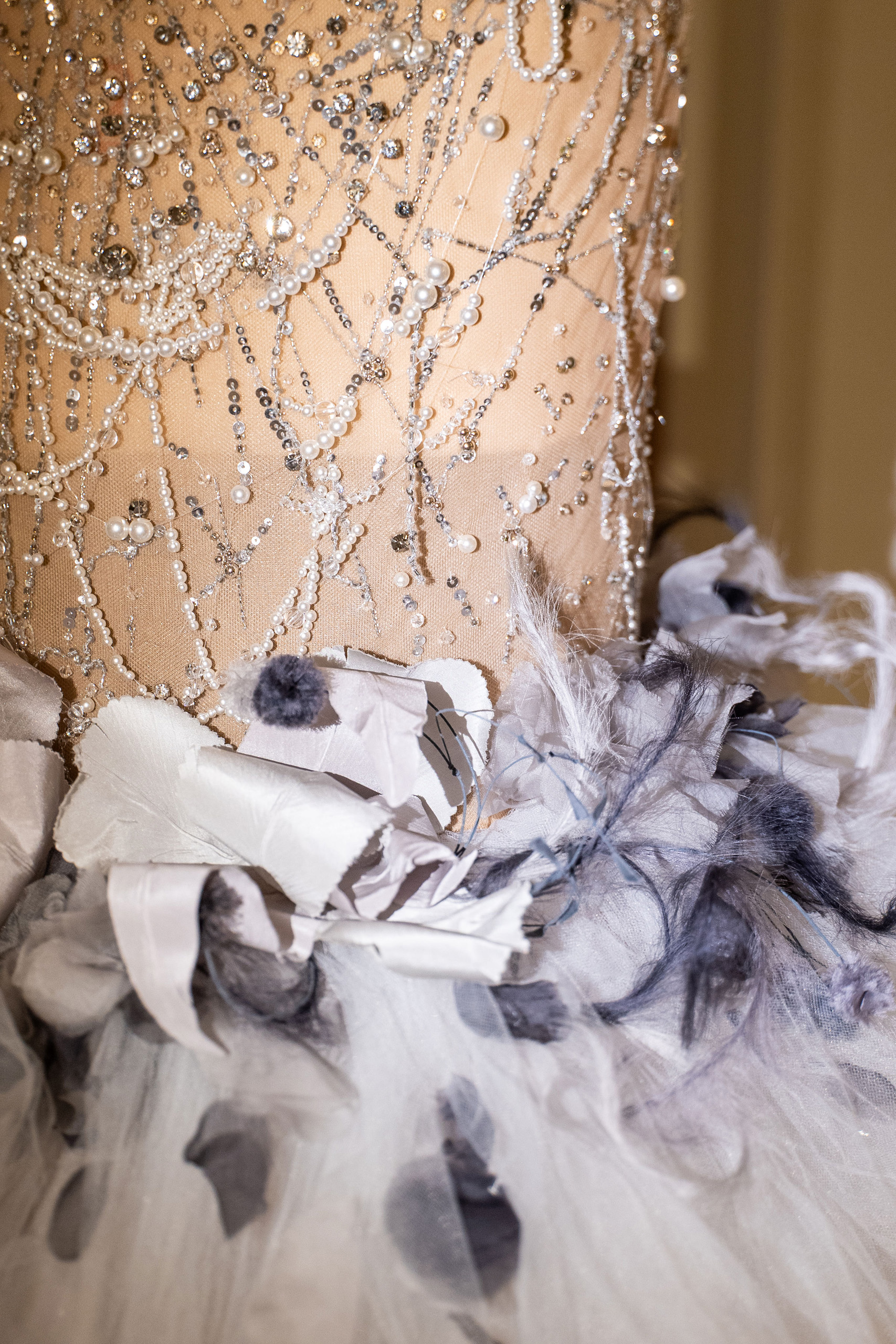 Close-up of beaded bodice and feathered tulle skirt detail