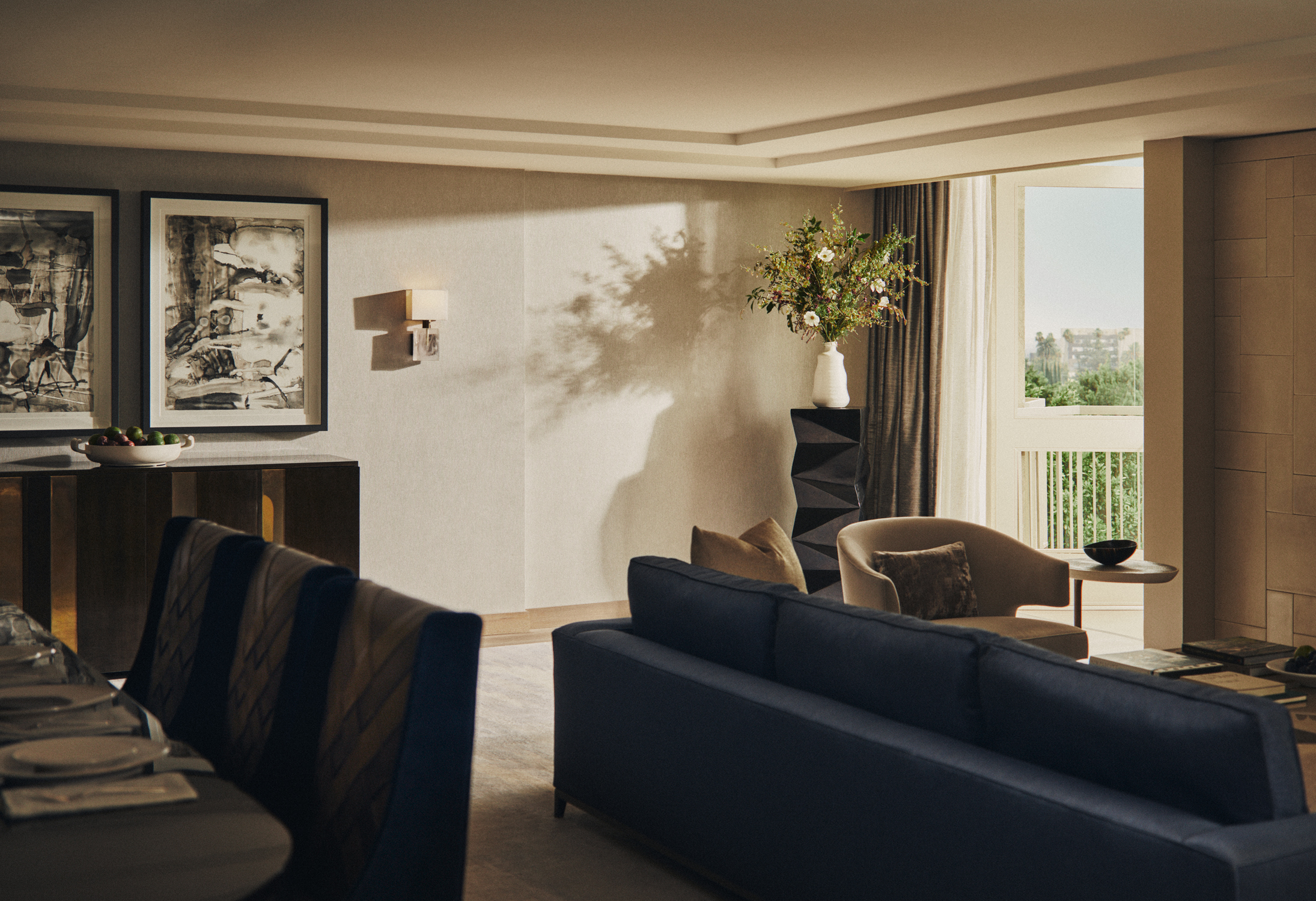 Palm Suite living room with sofa, dining area, artwork, and balcony views