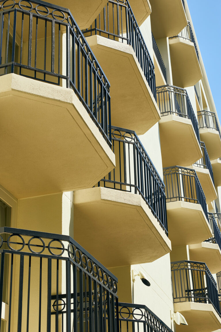 Angled view of stacked balconies with black railings