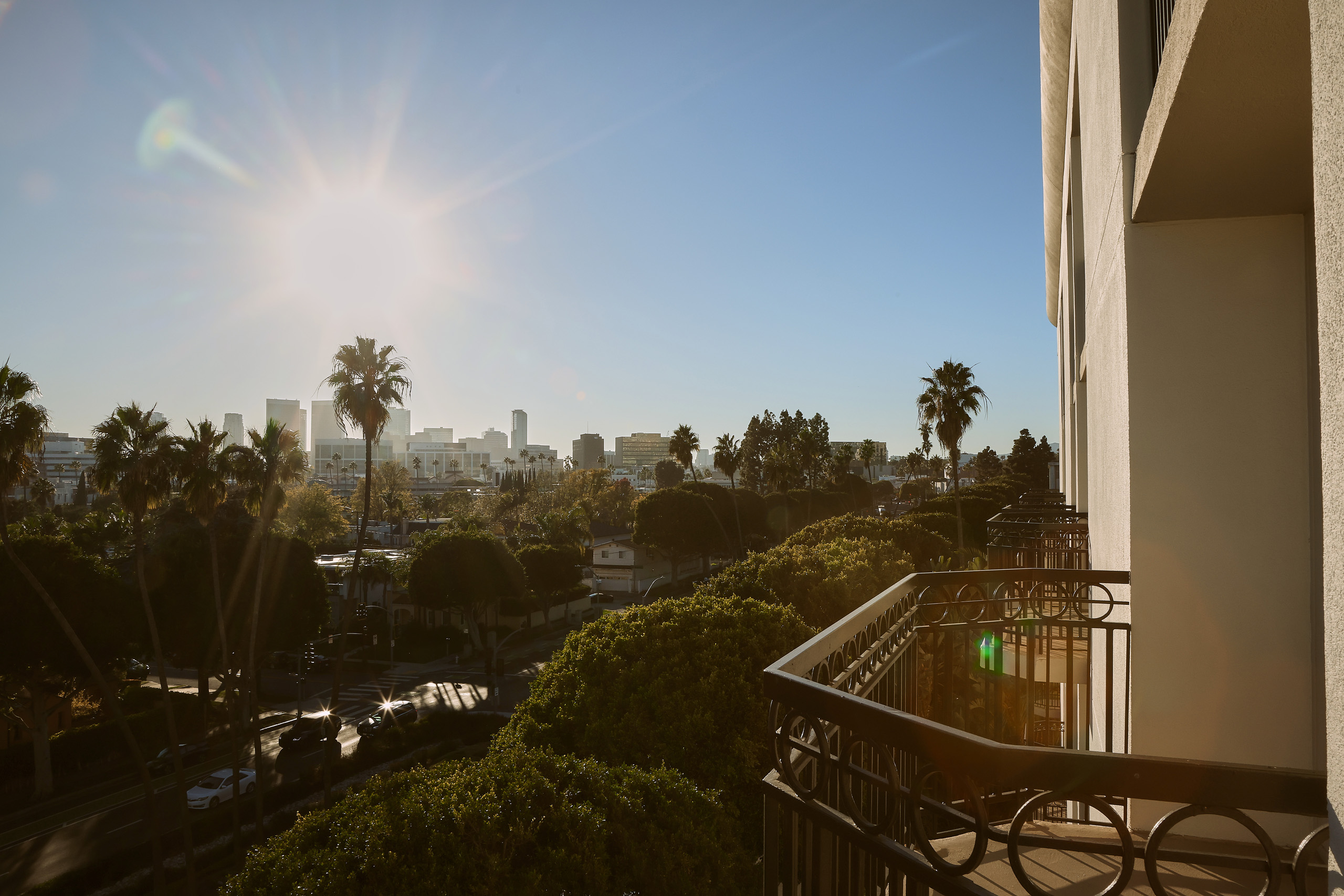 Balcony view over city skyline at sunset
