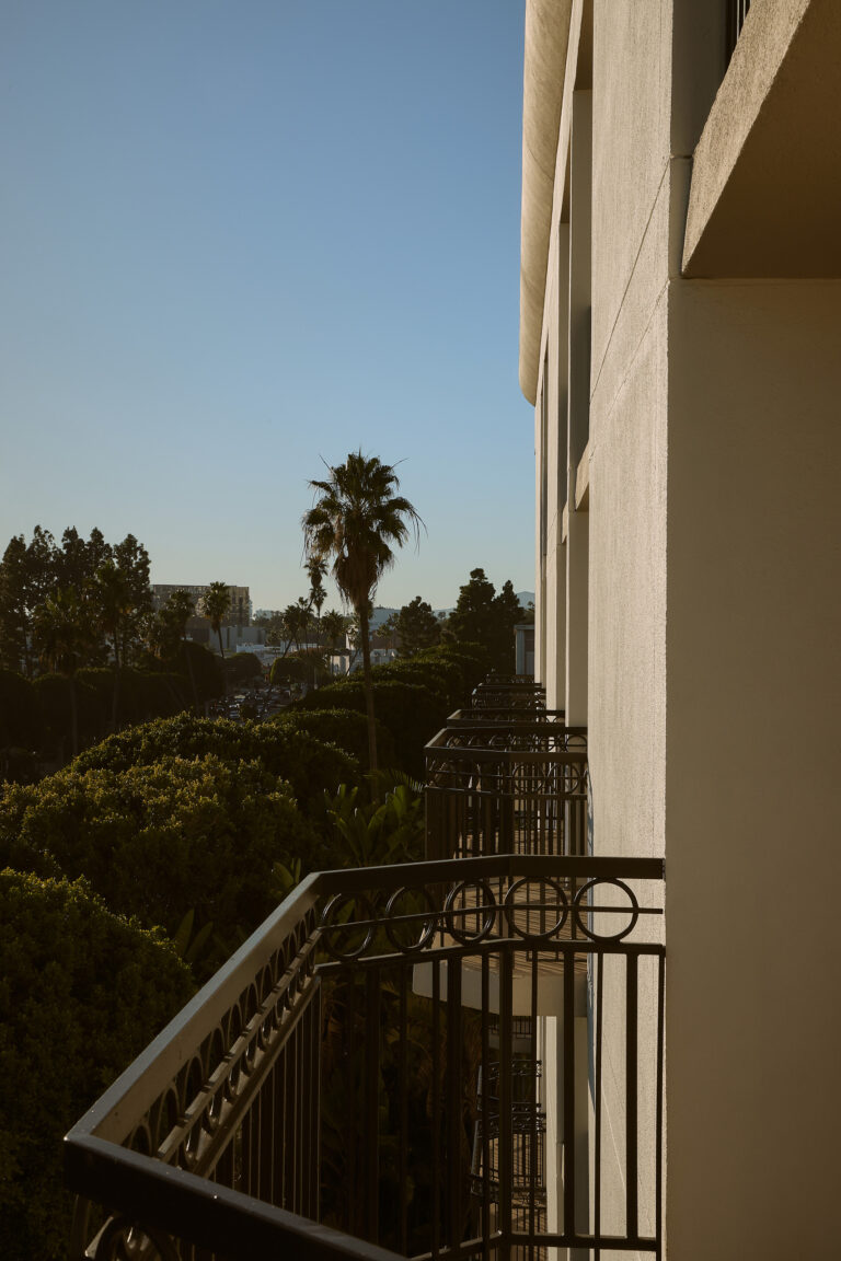 Golden-hour view of hotel balconies and greenery