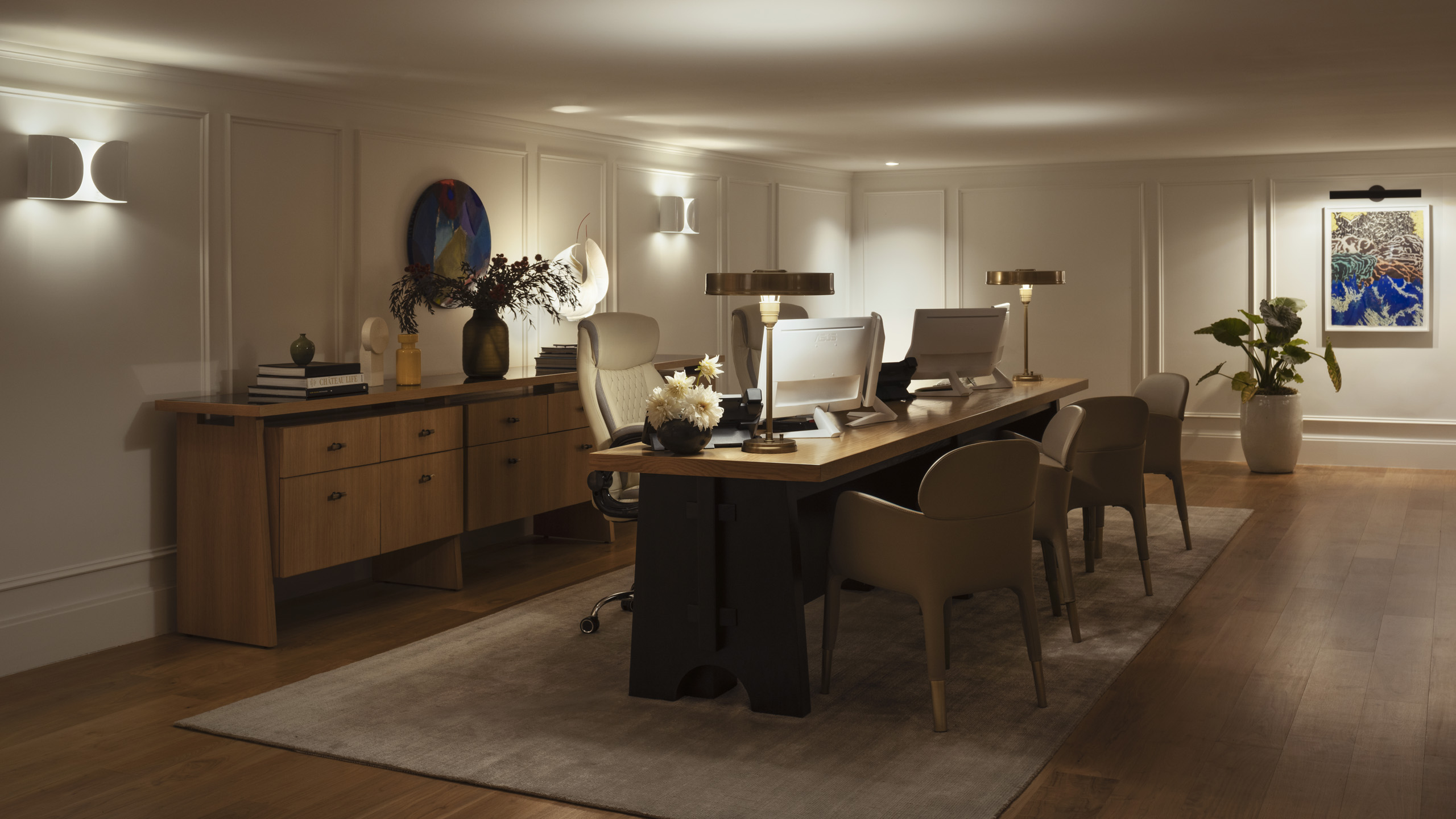 Elegant hotel lobby desk with staff and abstract artwork