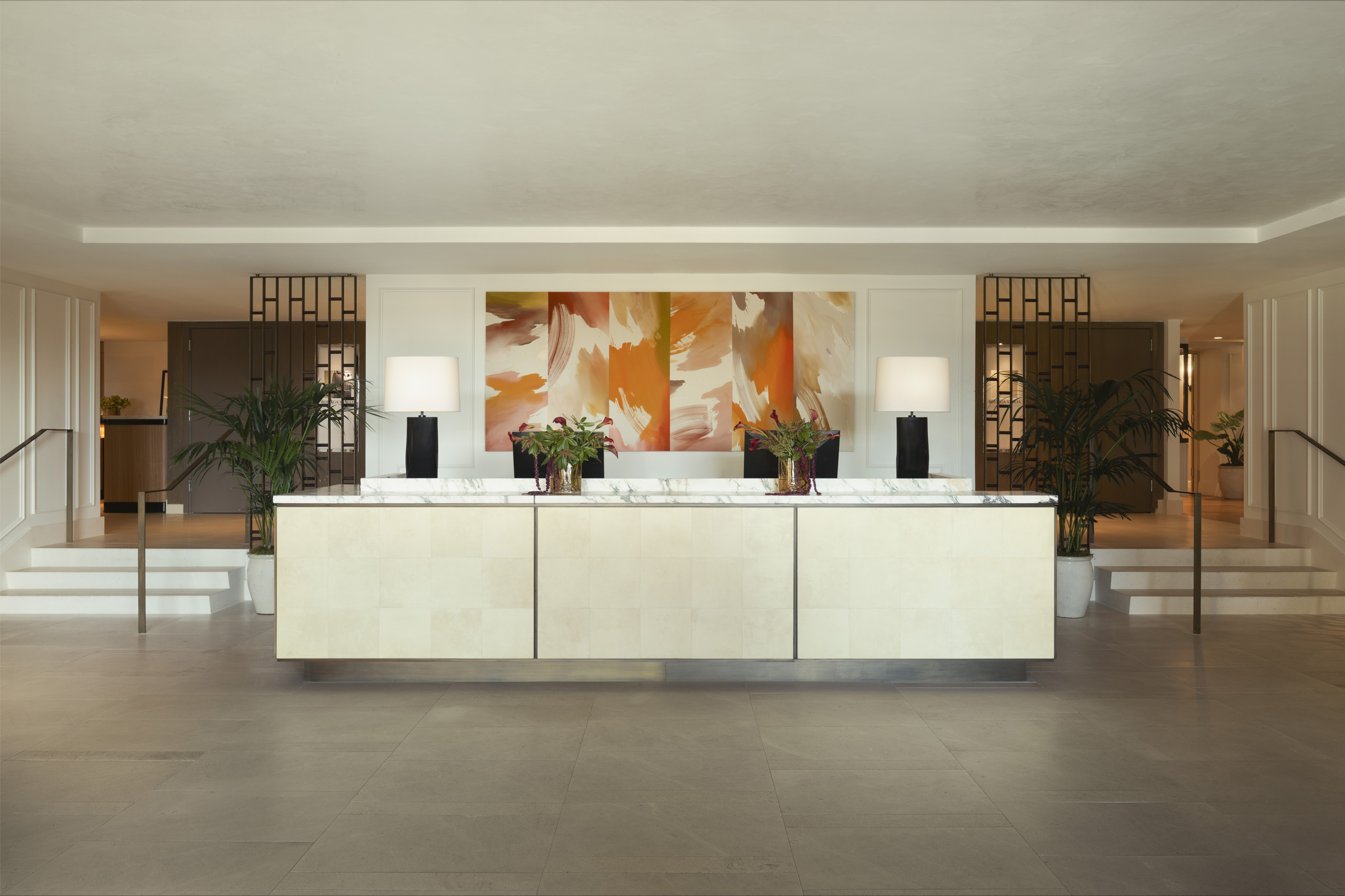 Bright hotel lobby front desk with abstract orange artwork