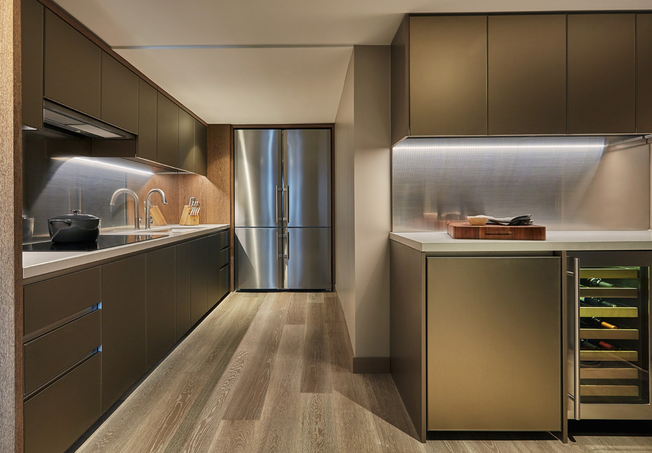 Full kitchen with sleek cabinetry, wine storage, and integrated appliances
