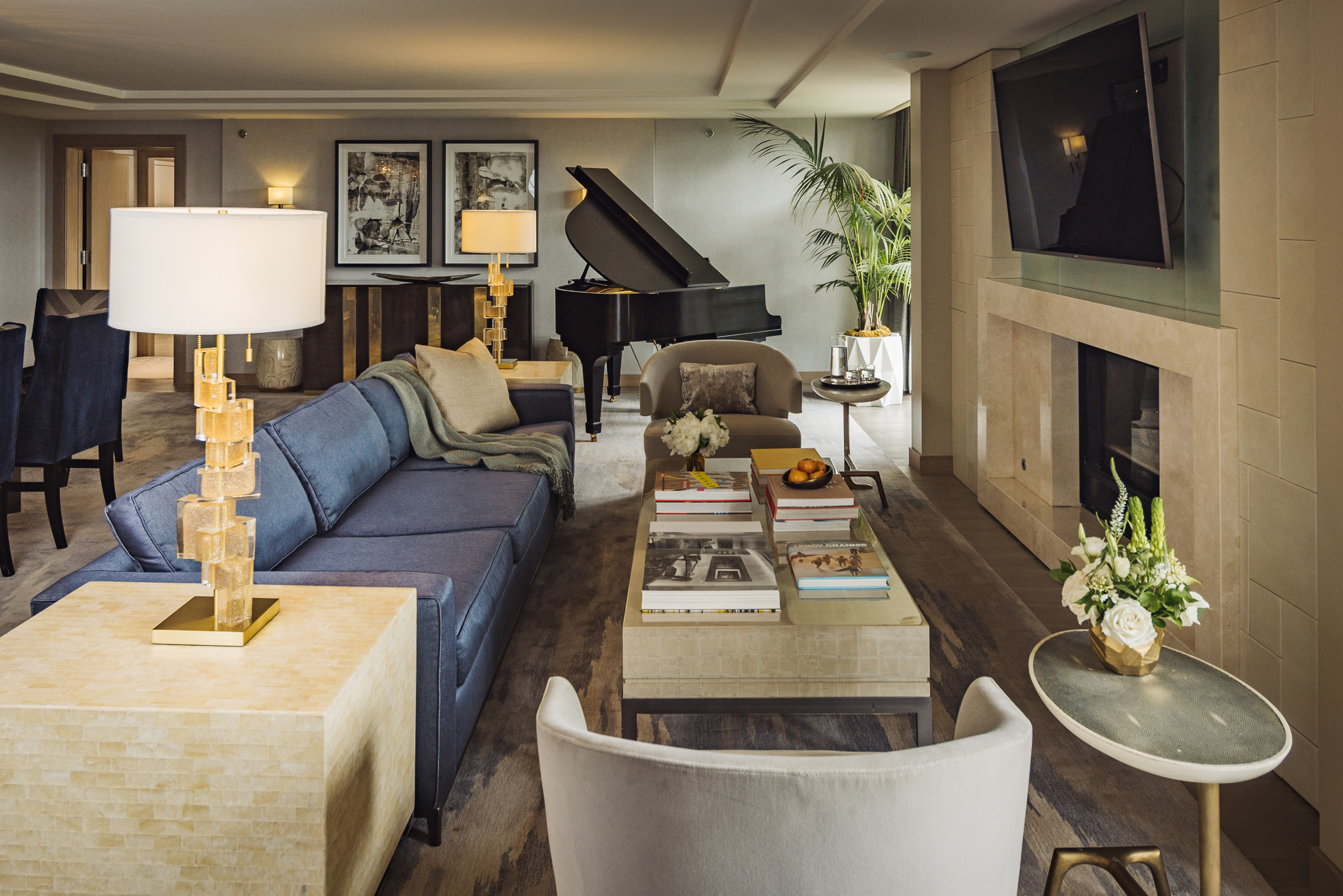 Spacious suite living and dining room with chandelier.