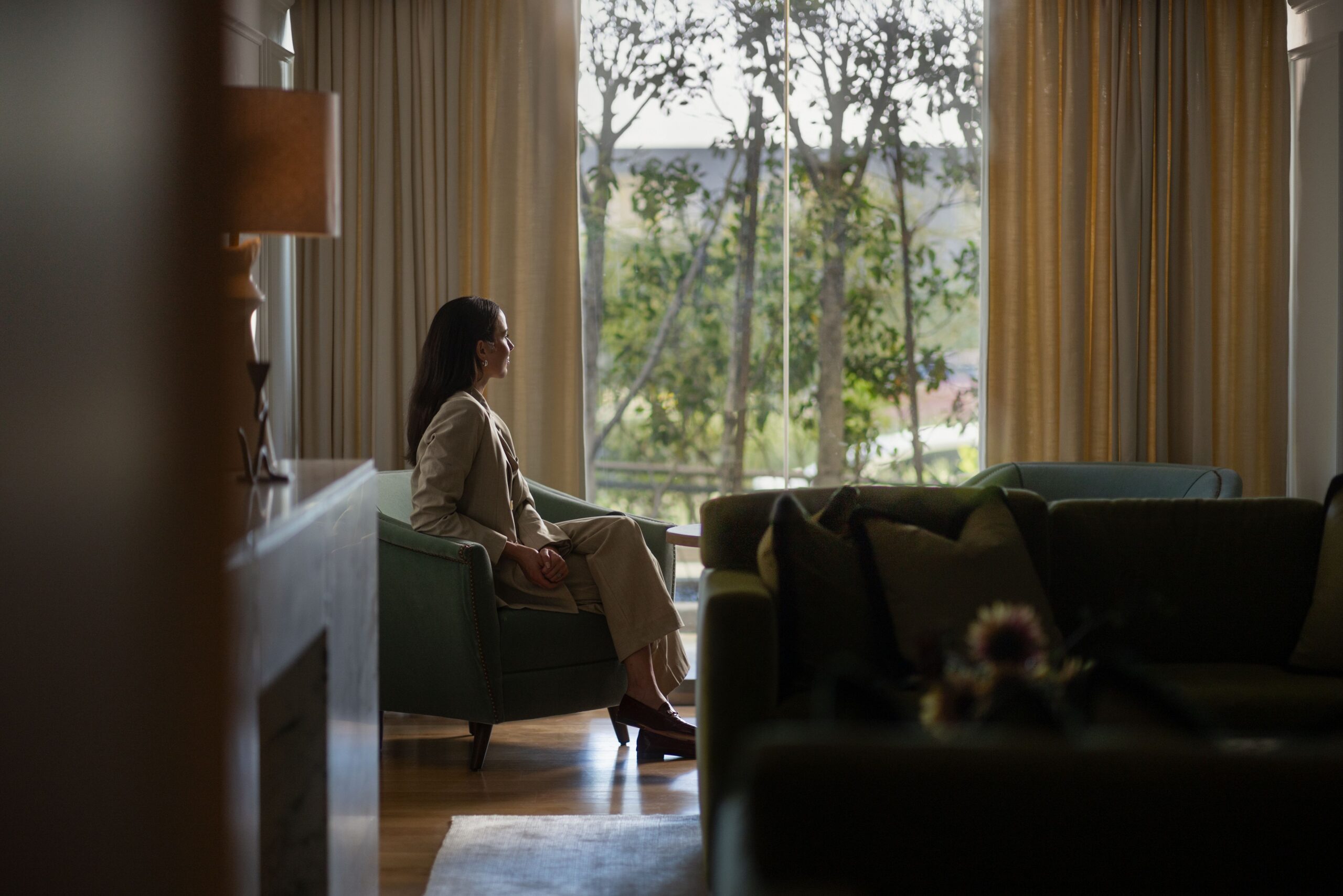 Woman in hotel room looking outside