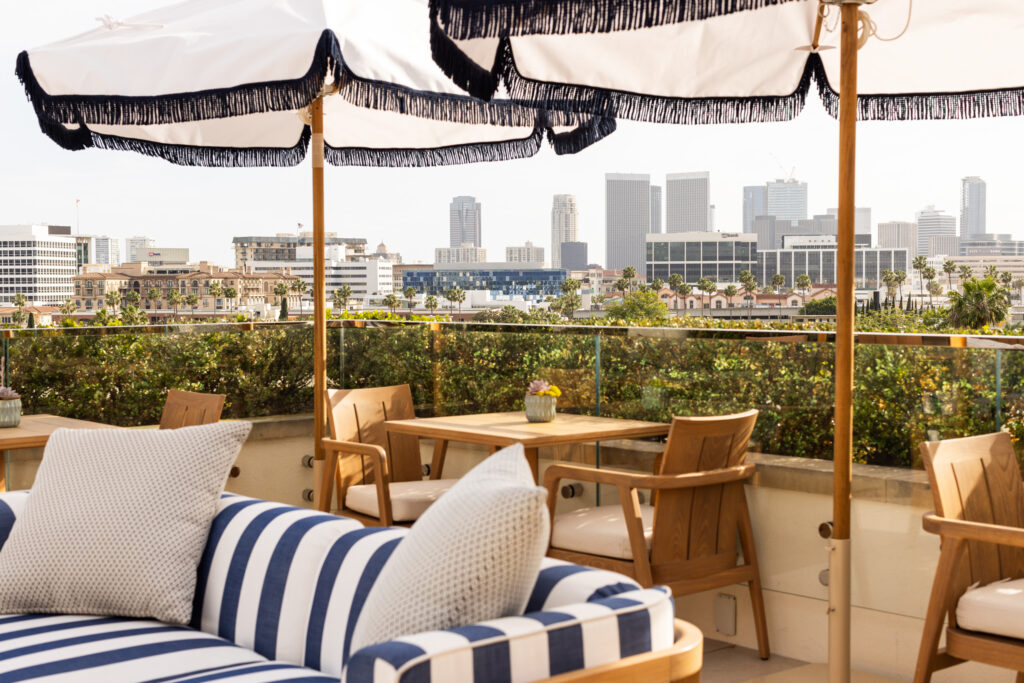 Rooftop patio seating overlooking downtown skyline.