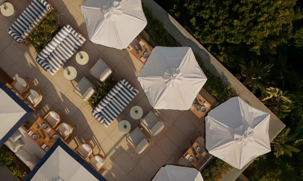 Aerial view of rooftop lounge with umbrellas and seating.