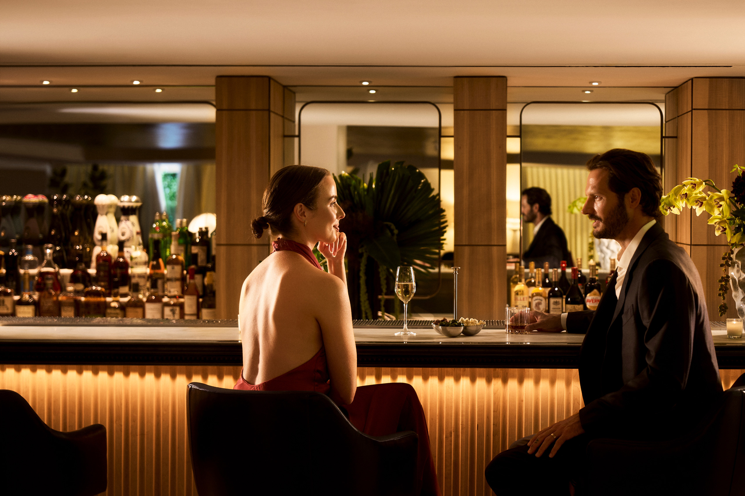 Couple enjoying cocktails at an elegant hotel bar