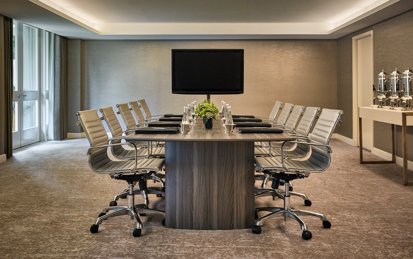 Elegant meeting table with vase and soft lighting