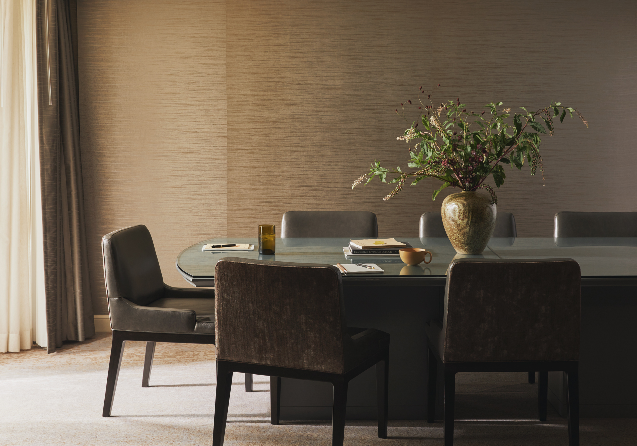 Modern boardroom with long table and screen