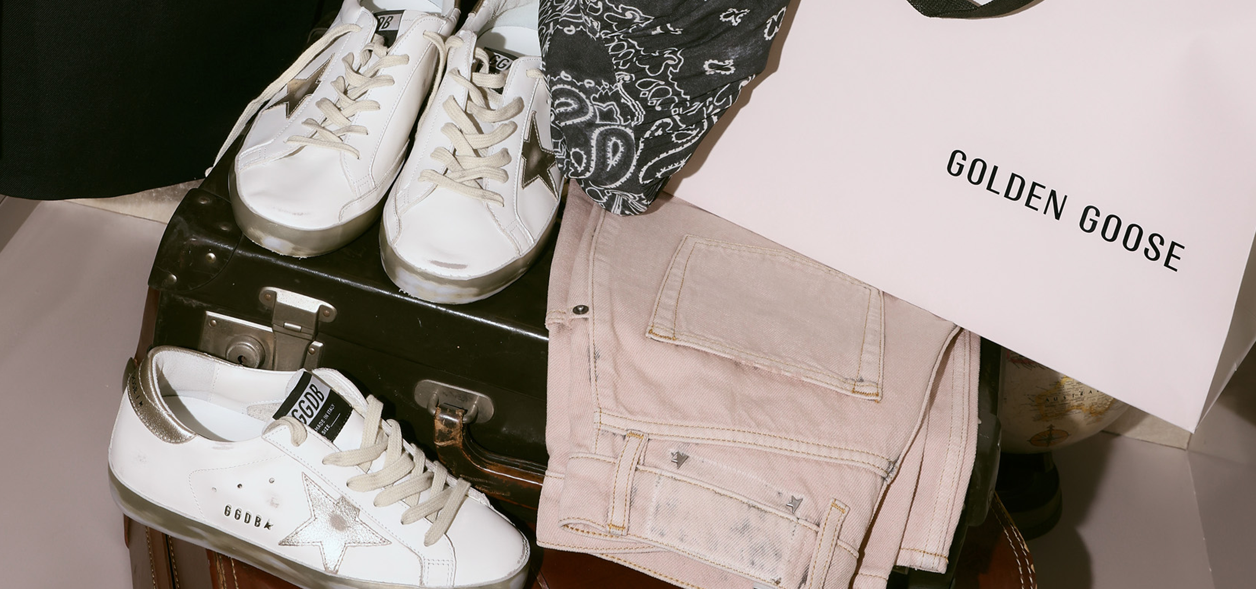 Closet scene with Golden Goose bag and hanging sneaker