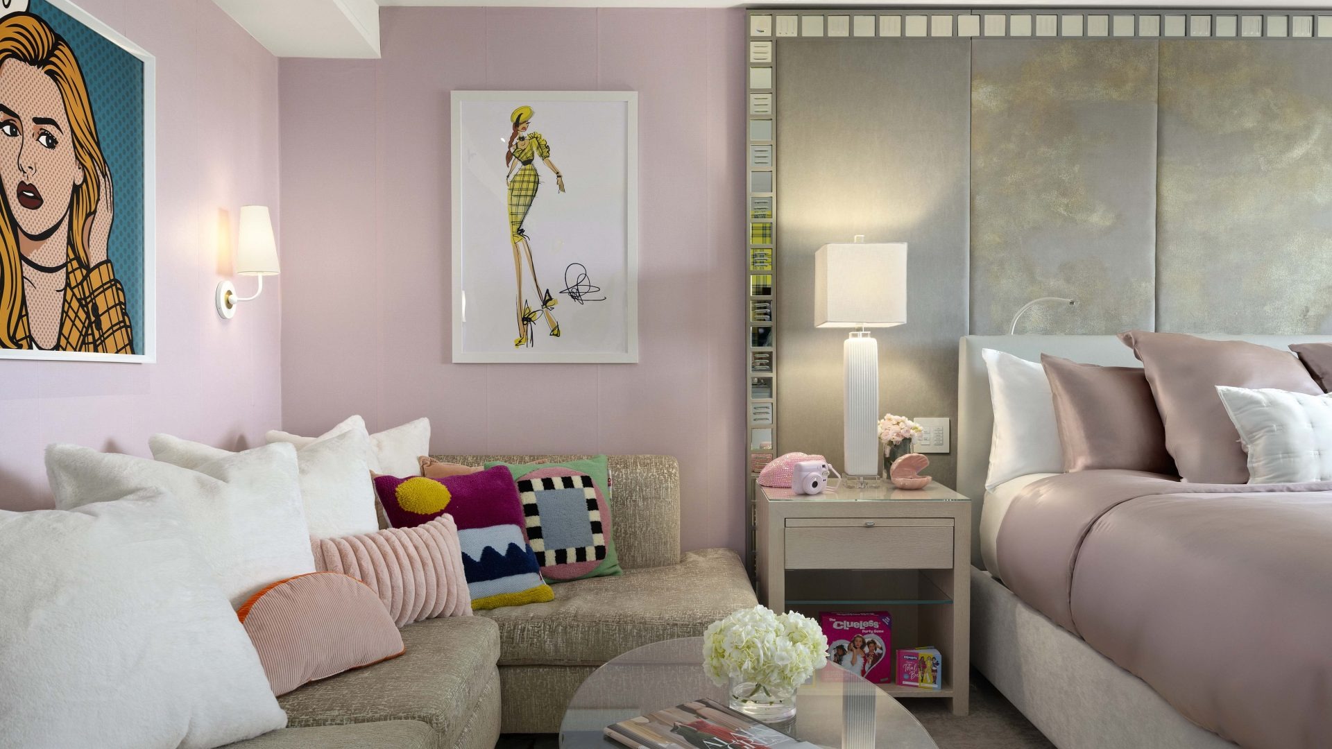 Pastel bedroom lounge area with sofa and artwork