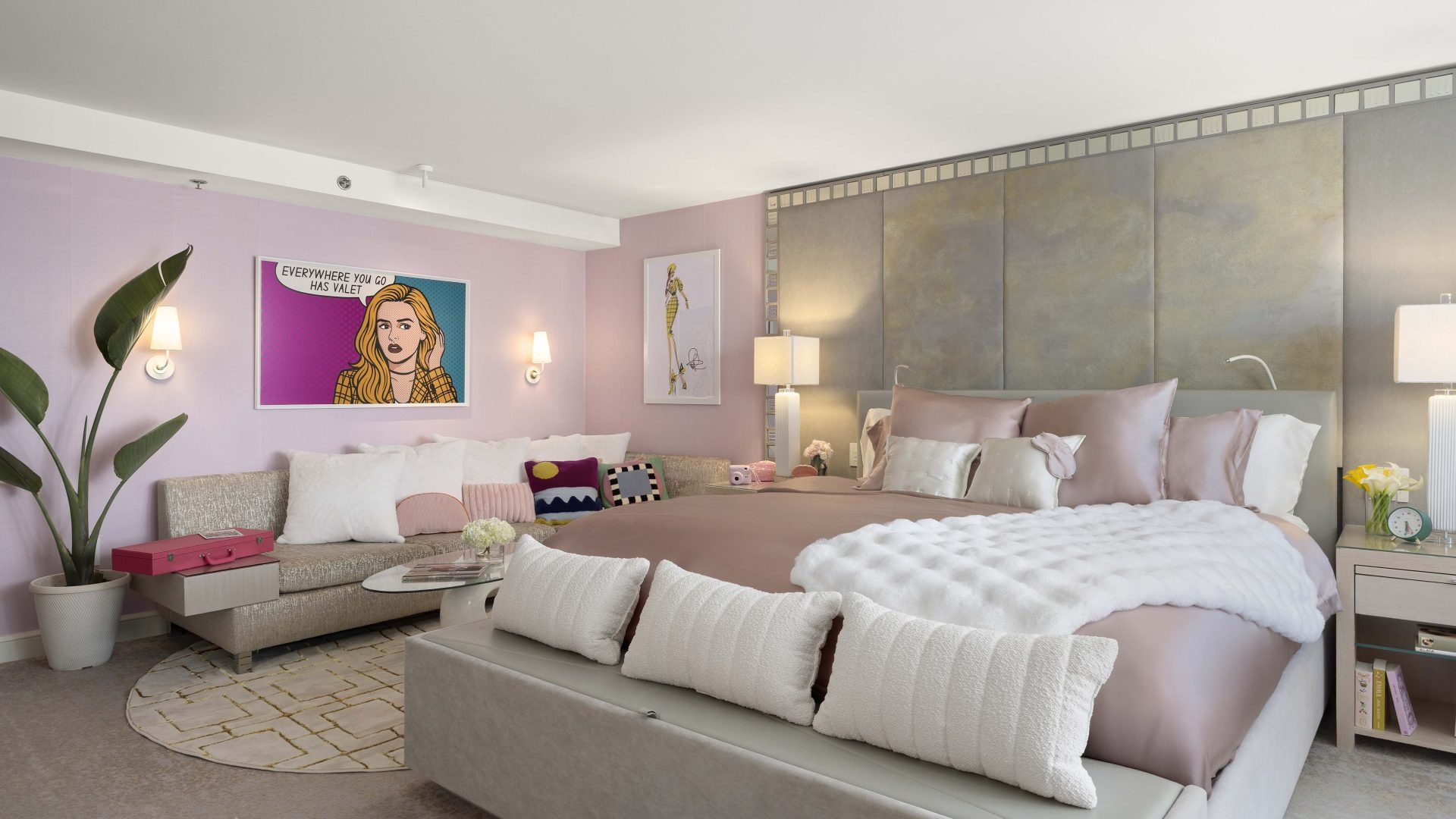 Wide view of pink suite with bed and seating